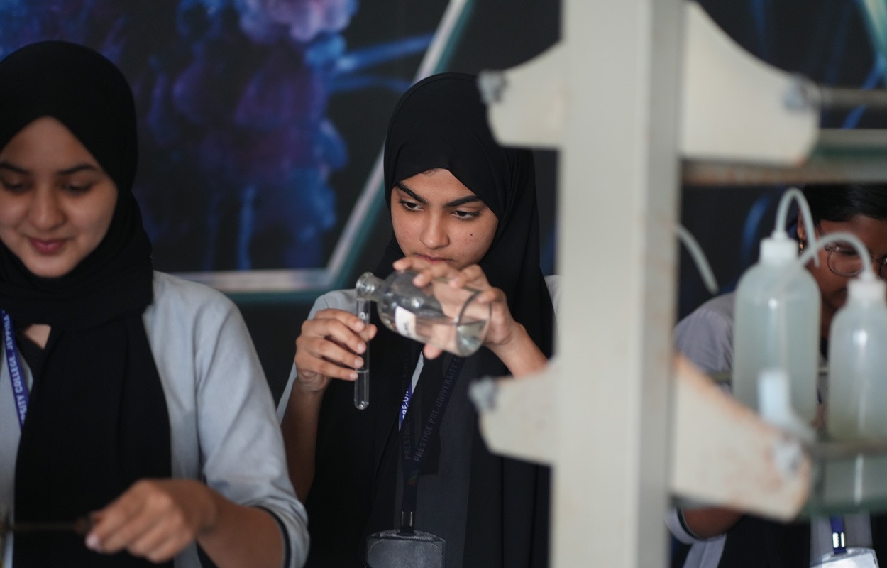 “Students performing a science experiment in a laboratory.”