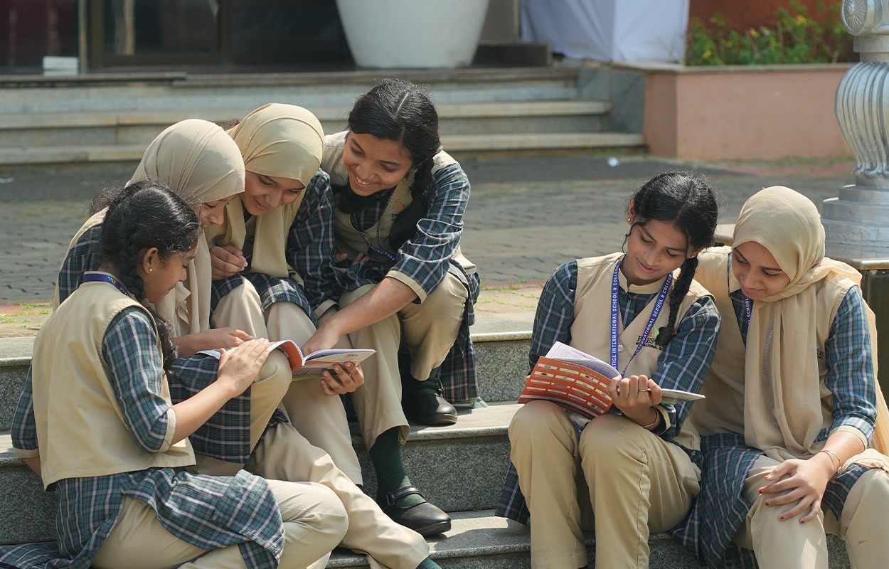 Prestige school students sitting on campus steps, studying together in uniform
